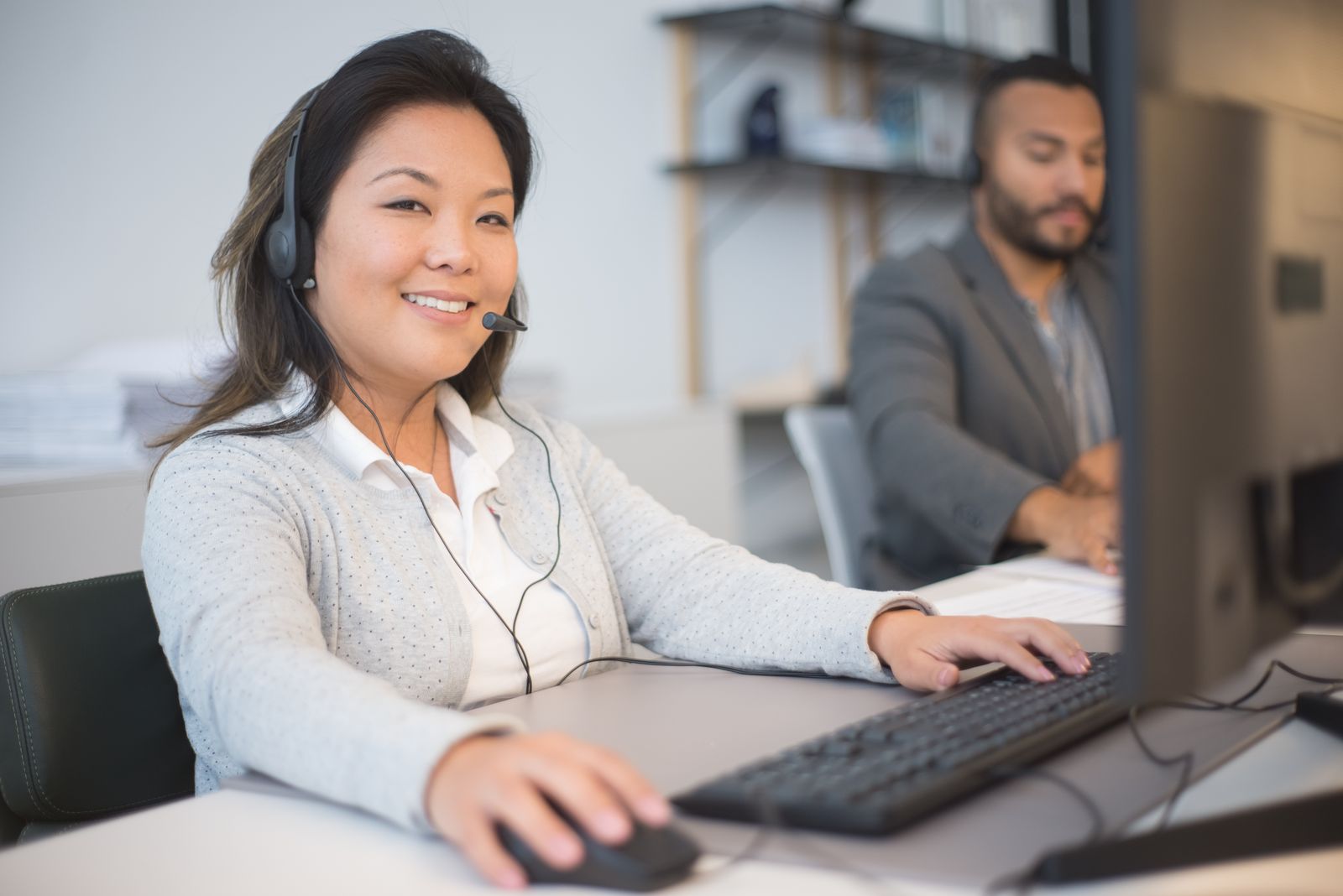 Woman with a headset working on a computer